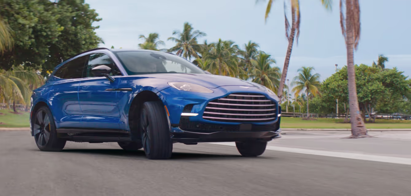 Aston Martin DBX707 campaign still, suv screeching around a corner
